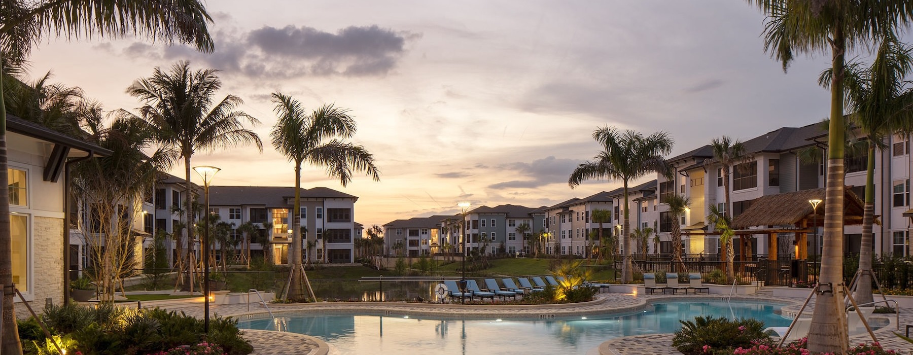 pool with lounge chairs at dusk