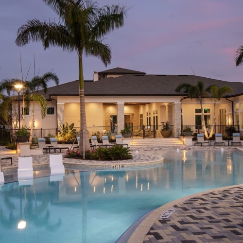 Sparkling swimming pool pool with lounge chairs